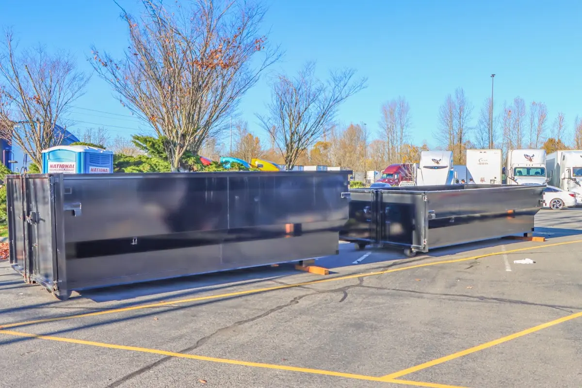 Professional dumpster rental service with roll-off container on residential driveway in Vero Beach